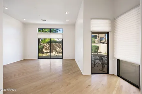 an empty room with windows and entrance