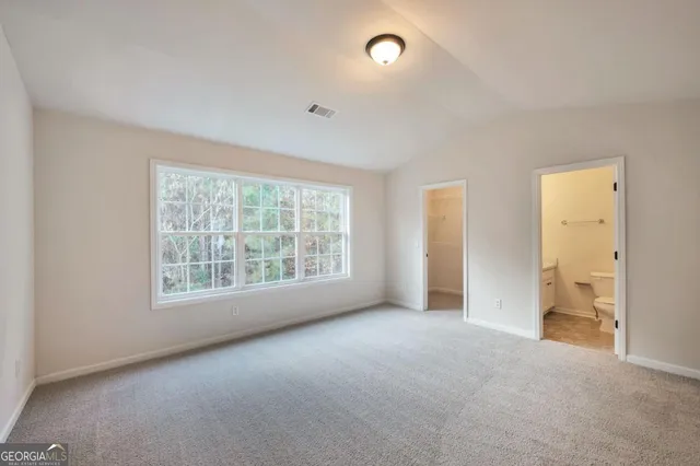 a view of an empty room and a window