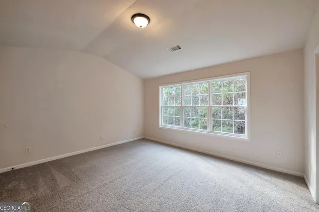 a bathroom with a granite countertop sink a toilet and a mirror