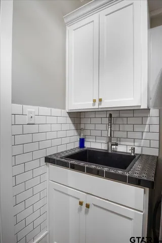 a white toilet sitting next to a bathroom sink