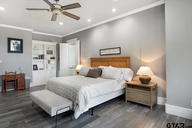 a bathroom with double vanity sinks a large mirror and a bathtub