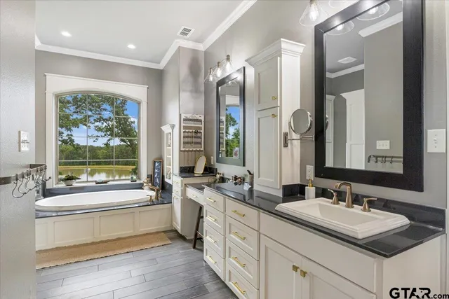 a bathroom with bathtub and window