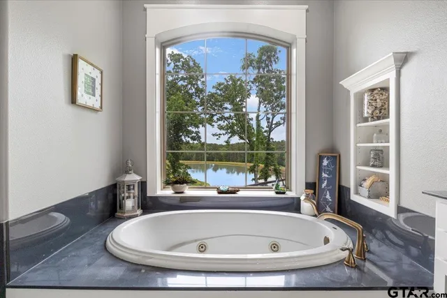 a spacious bathroom with a double vanity sink a mirror and a shower