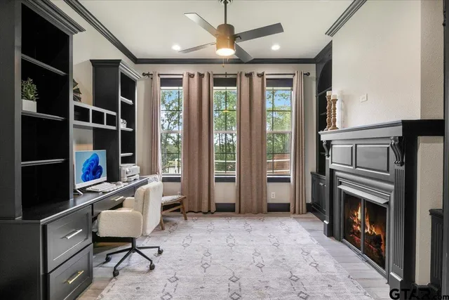 a view of staircase with lots of frames on wall and a large window