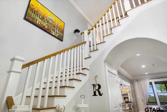 a view of a hallway with wooden floor and staircase