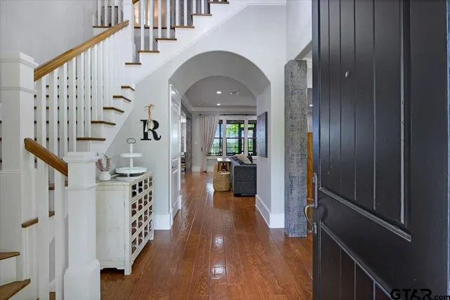 a view of entryway and hall with wooden floor