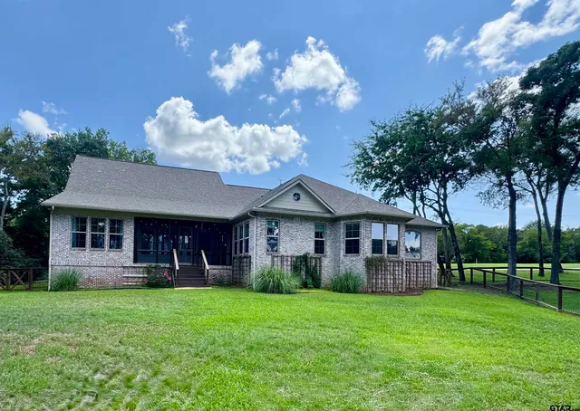 a view of a house with a yard and a garden
