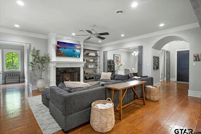 a living room with furniture a fireplace and a flat screen tv