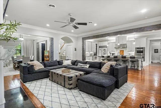 a living room with furniture and wooden floor