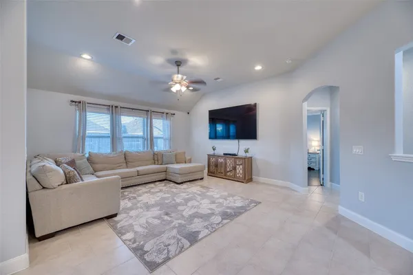 a living room with furniture and a flat screen tv