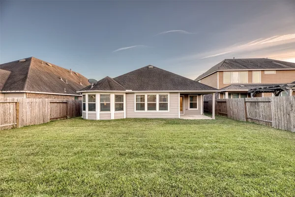 a front view of house with yard and green space