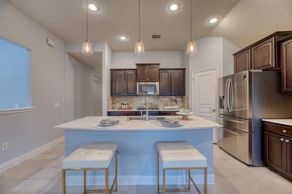 a kitchen with kitchen island appliances cabinets and furniture