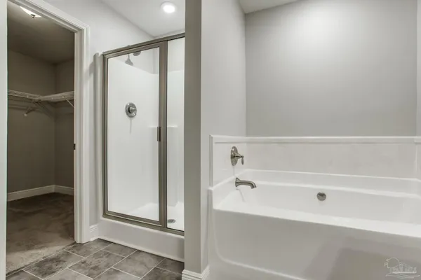 a bathroom with a granite countertop sink a light fixture and a mirror