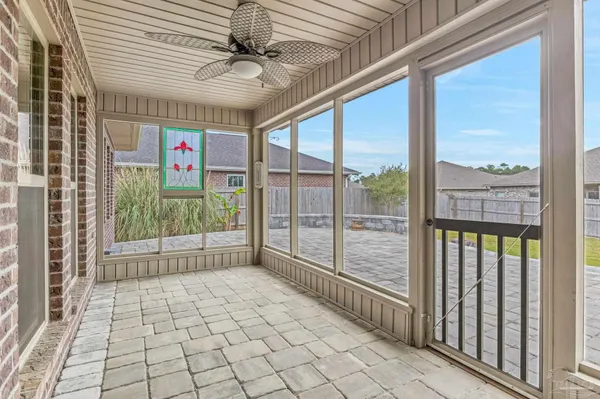 a view of a livingroom with a ceiling fan and window