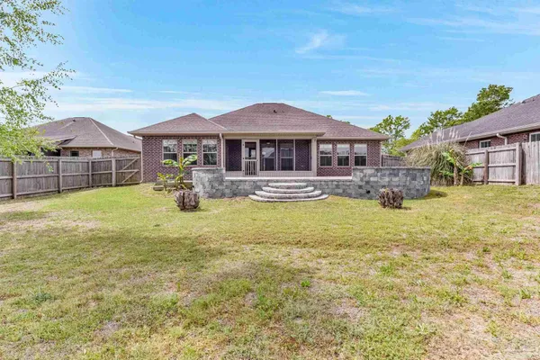 a view of a house with a yard and sitting area