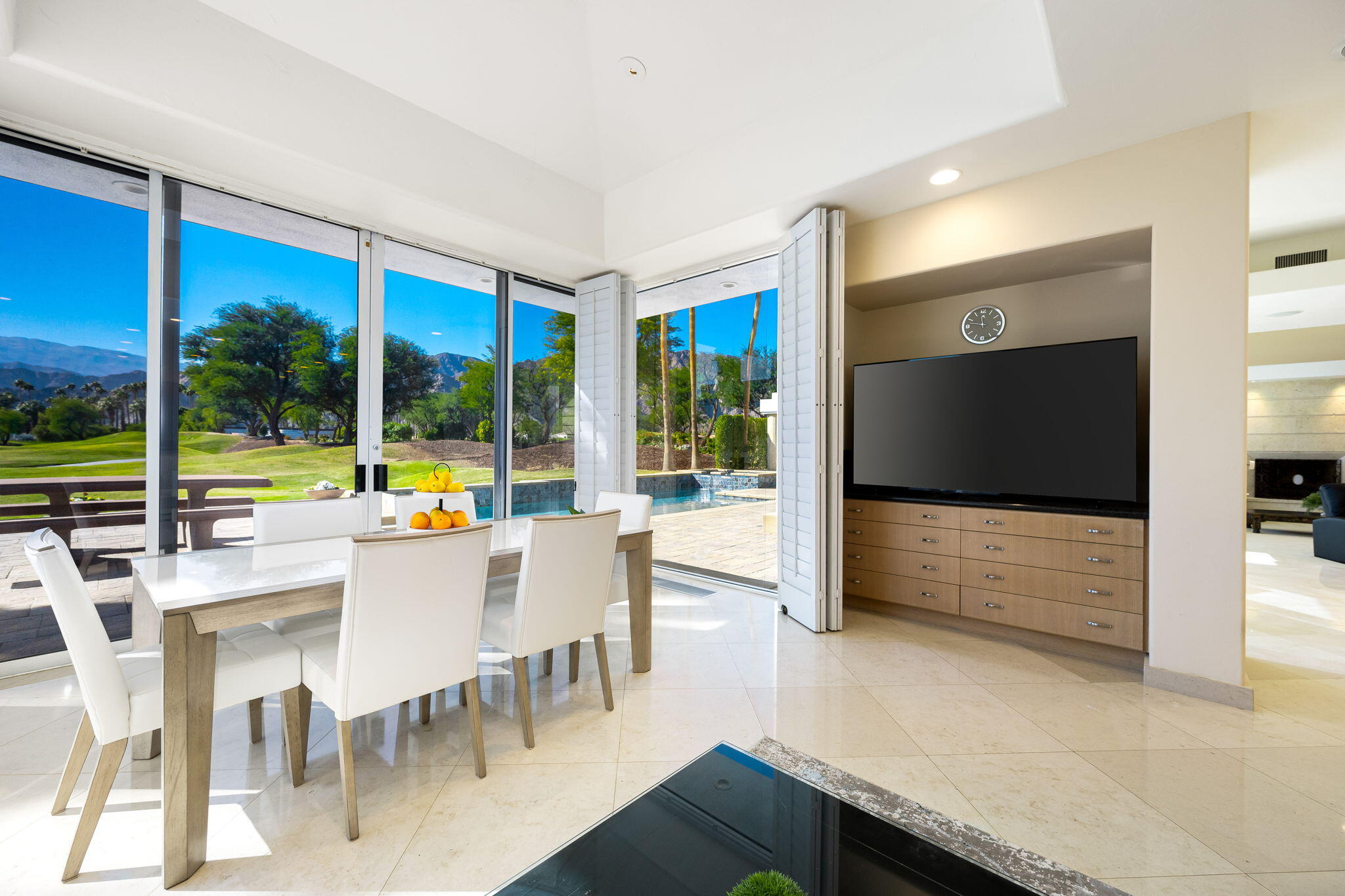 55305 Pebble Beach La Quinta, CA 92253 - Photo 21 of 65 a view of a dining room with furniture wooden floor and floor to ceiling window