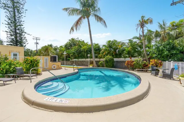 a view of a swimming pool with a dining room