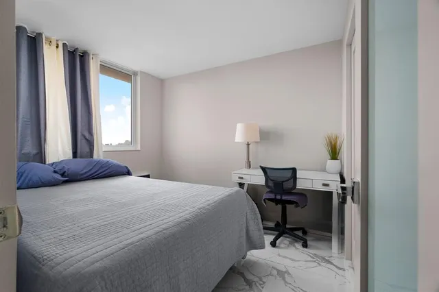 a bedroom with a bed and a chair