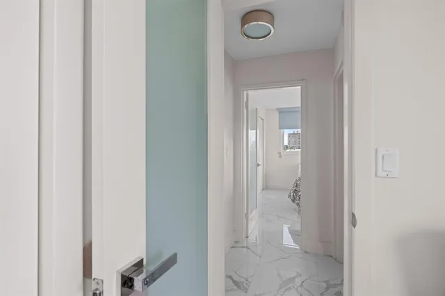 a bathroom with a granite countertop toilet a sink and a mirror