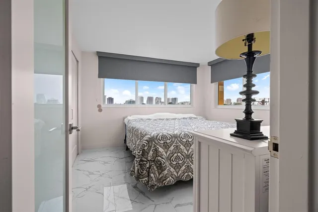 a living room with a large window and a wooden floor