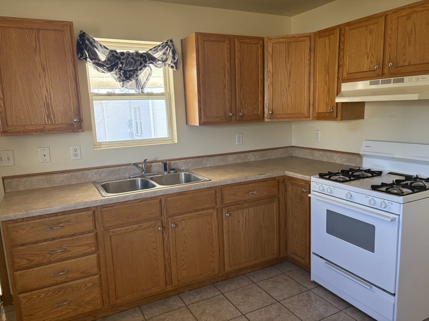 221 North 9th Street Rochelle, IL 61068 - Photo 5 of 17 a kitchen with cabinets appliances a sink and a window