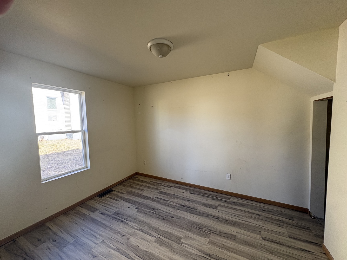 221 North 9th Street Rochelle, IL 61068 - Photo 9 of 17 an empty room with wooden floor and windows