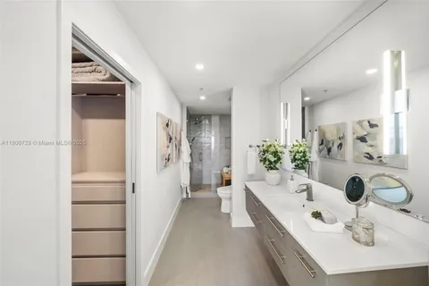 a bathroom with a tub sink and mirror