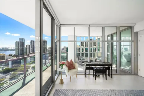 a bedroom with a bed a table and chair