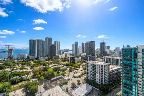 a living room with furniture and large windows