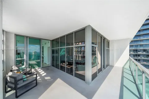 a view of a balcony with wooden benches