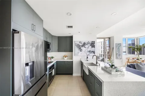 a large room with a large window and stainless steel appliances