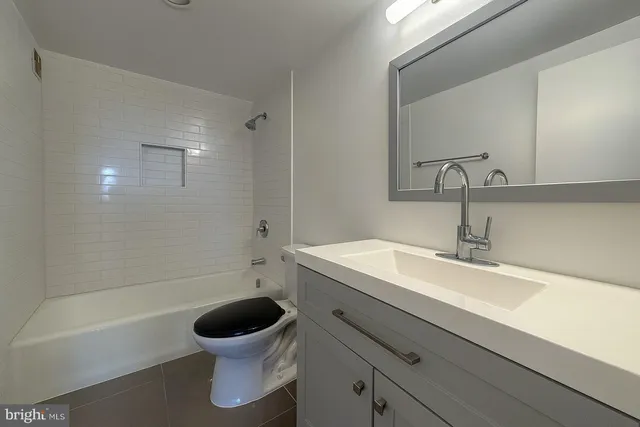a bathroom with a sink a toilet and a bathtub