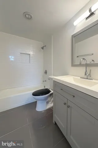a bathroom with a sink a toilet and a bathtub