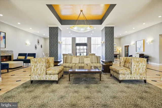 a living room with furniture and a chandelier