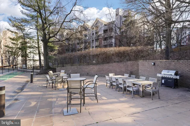 a view of a tables and chairs on the deck in front of house