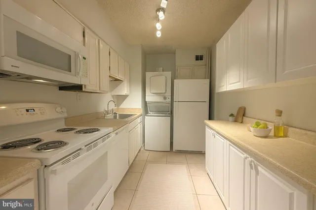 a kitchen with a sink a stove and refrigerator