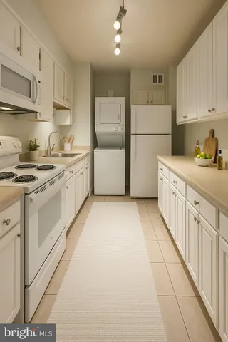 a kitchen with stainless steel appliances granite countertop a stove a sink and white cabinets