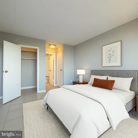 a bedroom with a bed and a painting