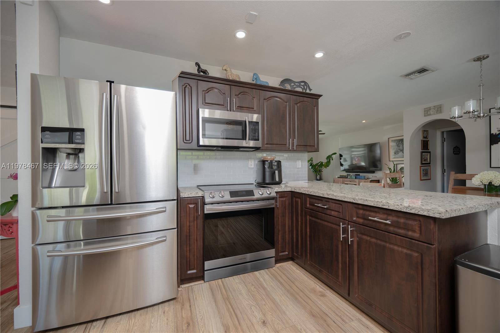 19431 Franjo Road Cutler Bay, FL 33157 - Photo 8 of 32 a kitchen with kitchen island granite countertop stainless steel appliances and sink