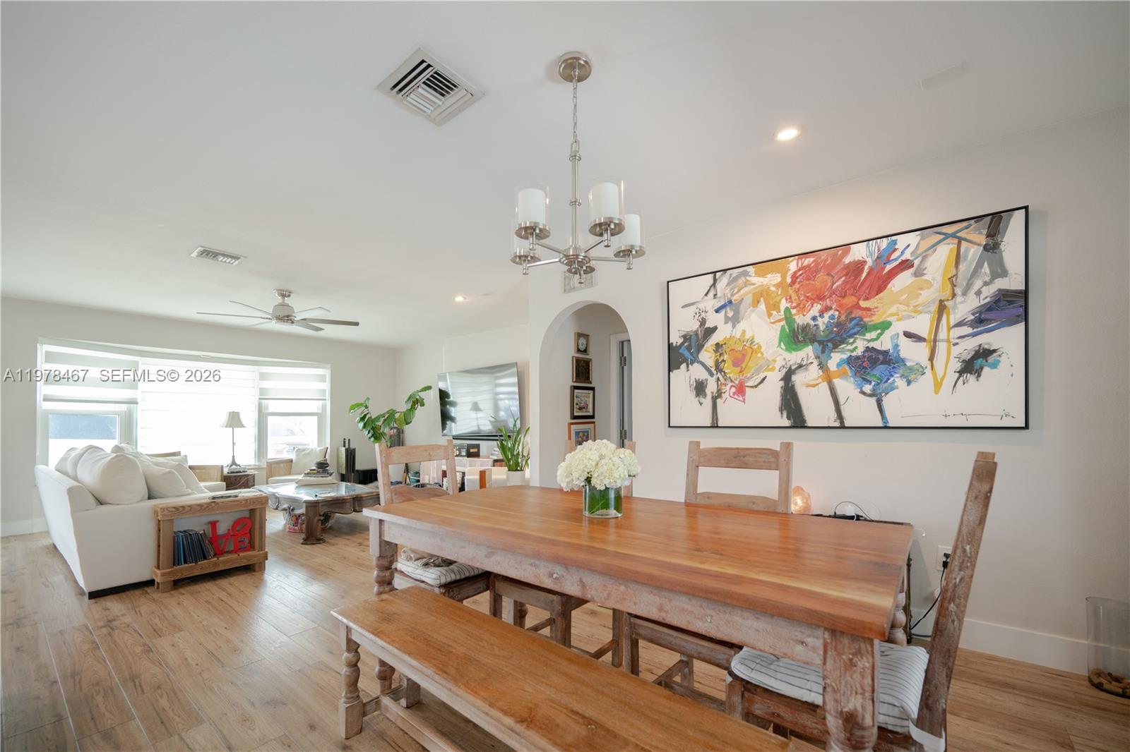 19431 Franjo Road Cutler Bay, FL 33157 - Photo 10 of 32 a view of a dining room with furniture a chandelier and wooden floor