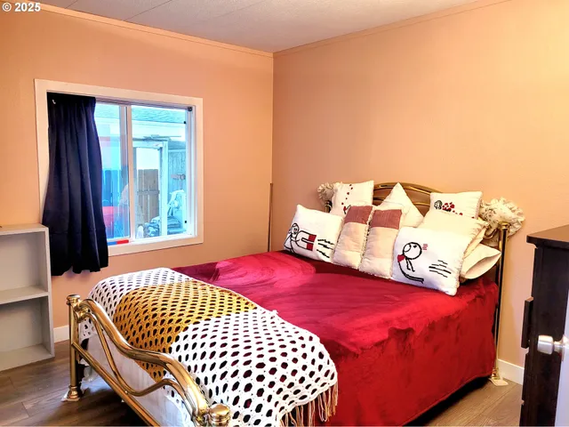 a bedroom with a bed and window