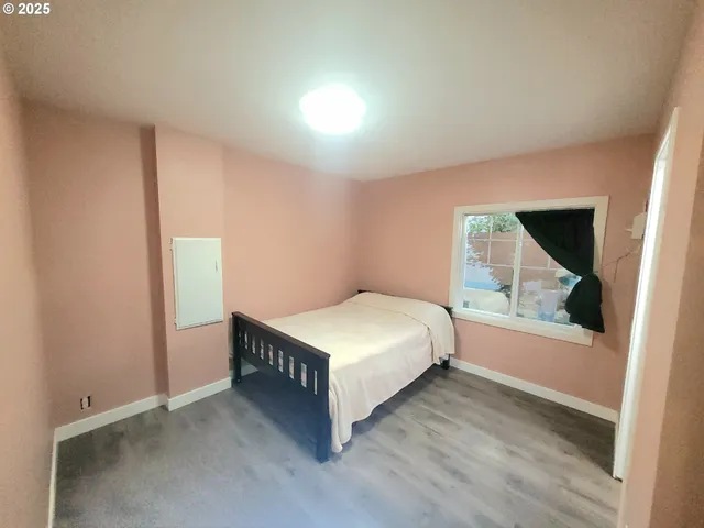 a living room with a bed and a window