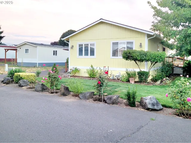 a view of a house with a garden and plants