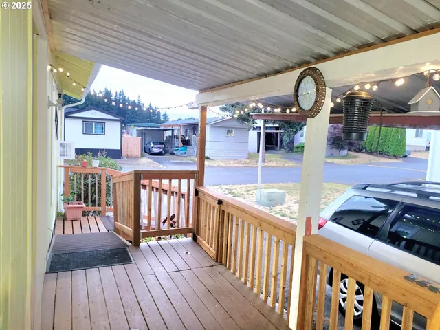 a view of a porch with furniture and wooden floor