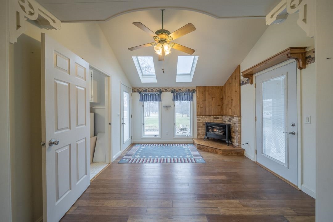 1431 Highway 75 Freeport, IL 61032 - Photo 34 of 34 a view of a livingroom with a fireplace a chandelier and wooden floor