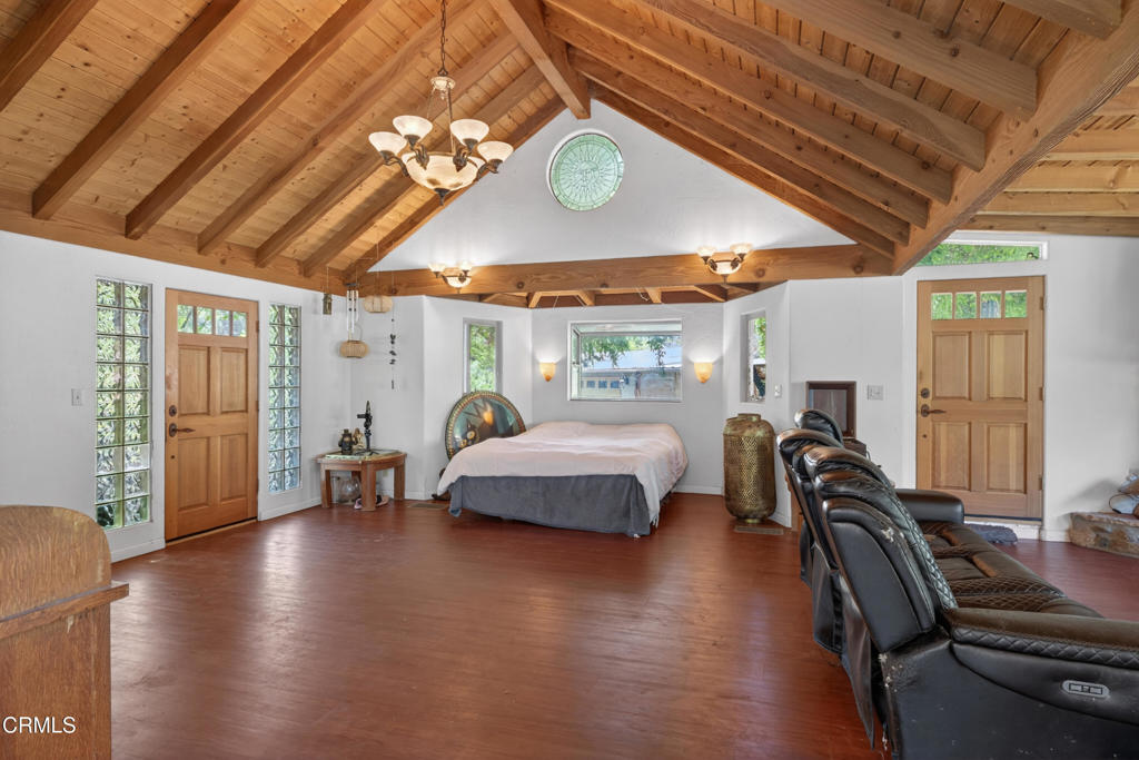 8416 Wheeler Canyon Road Santa Paula, CA 93060 - Photo 5 of 48 a bedroom with furniture and a chandelier