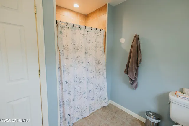a bathroom with a shower and a toilet