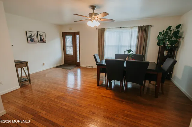 a view of a dining room with furniture and wooden floor
