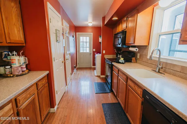 a kitchen with stainless steel appliances a sink stove and cabinets