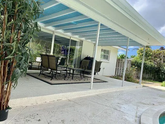 a view of a patio with table and chairs and potted plants